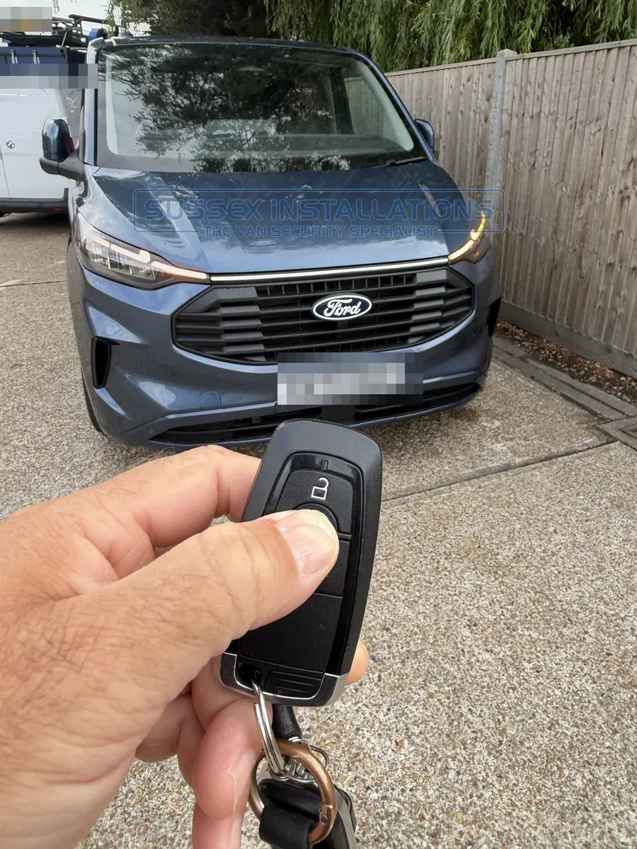 Pressing the lock button on a Ford Custom remote control twice to lock the van