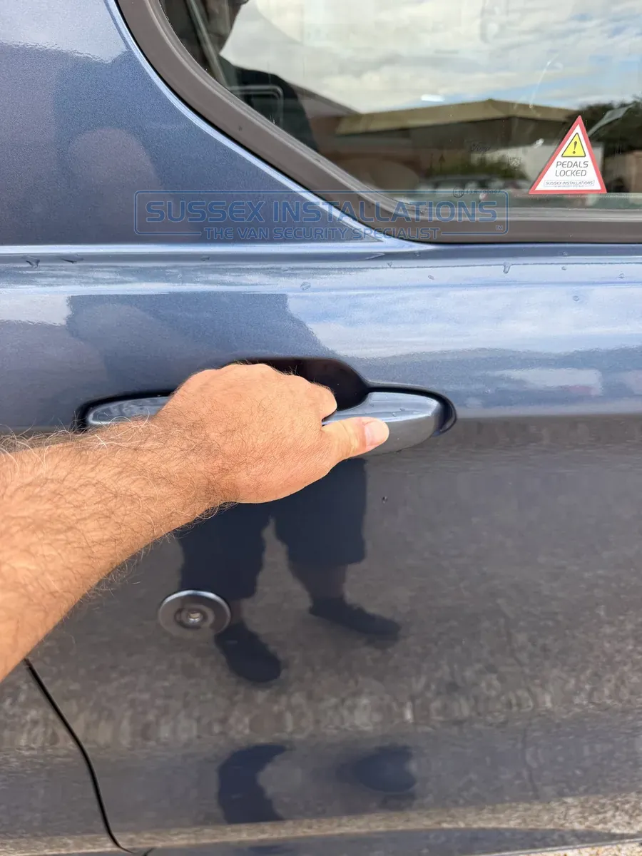 Opening the Ford Custom driver's door using the door handle after unlocking it with the manual key