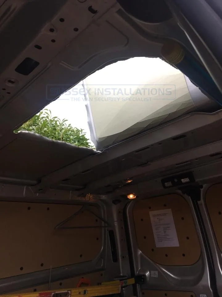 A hole cut through the roof of a van to gain entry