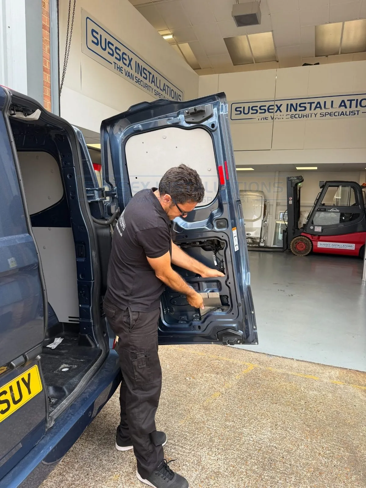 Jeff Scott examining a vehicle door and security protection