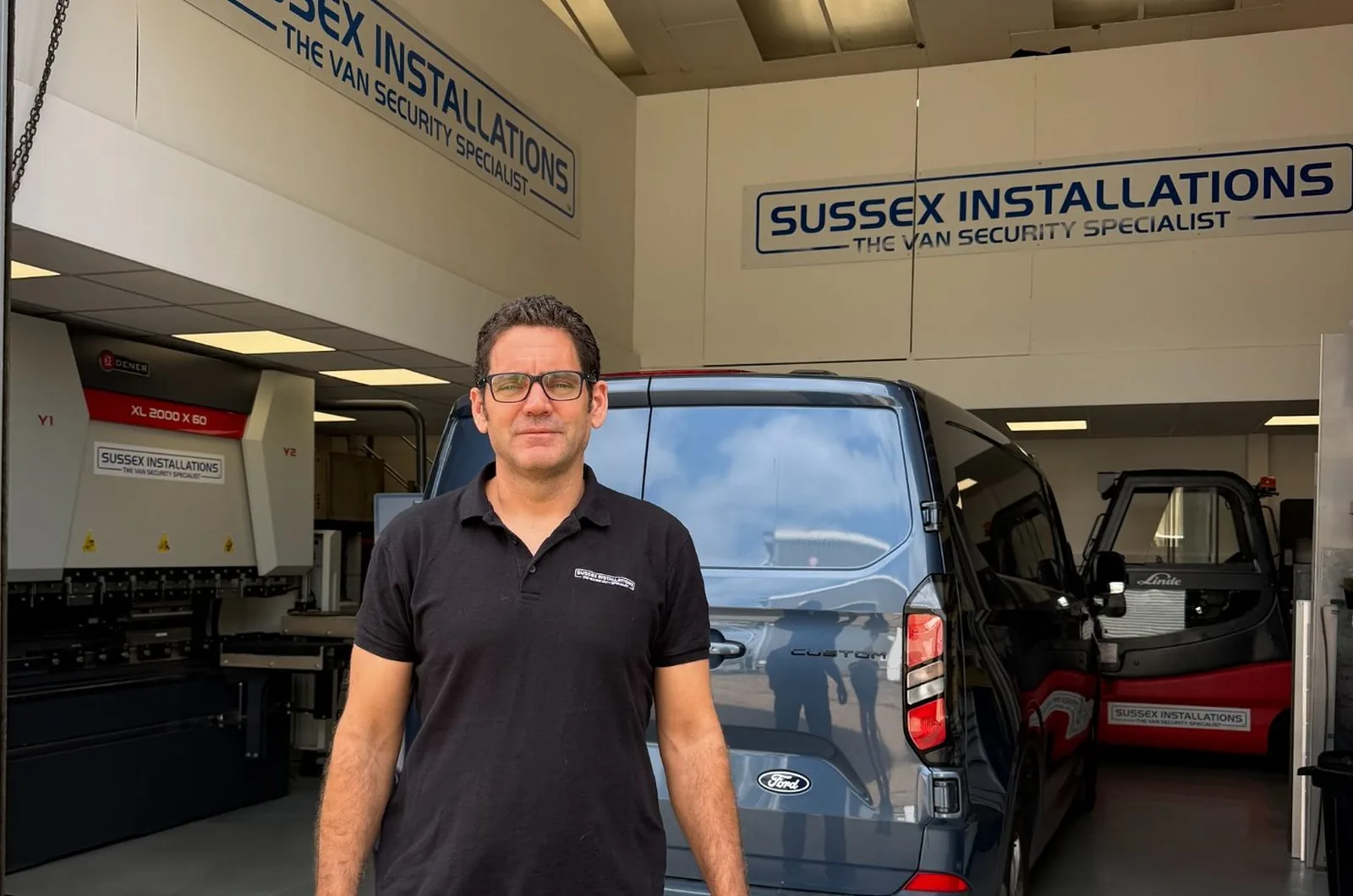 Jeff Scott standing in front of the Sussex Installations workshop
