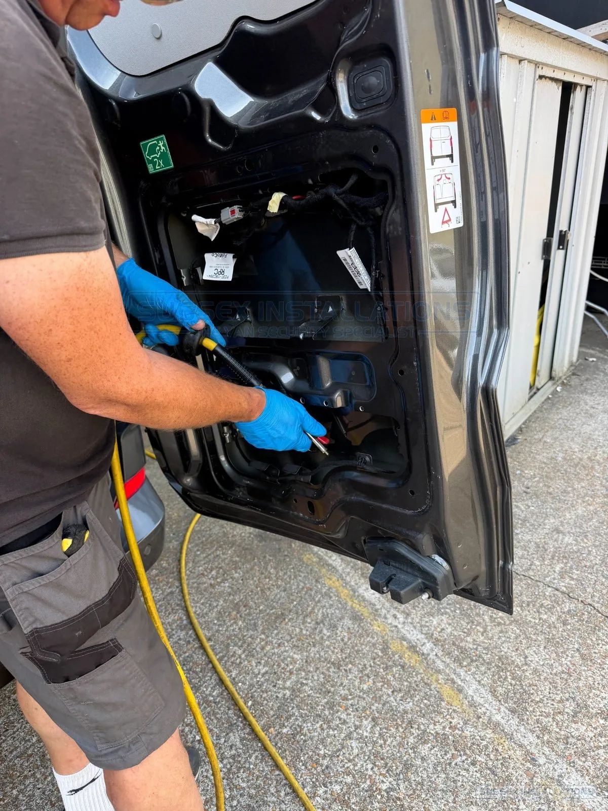 Installer cleaning the internal structure of a van door