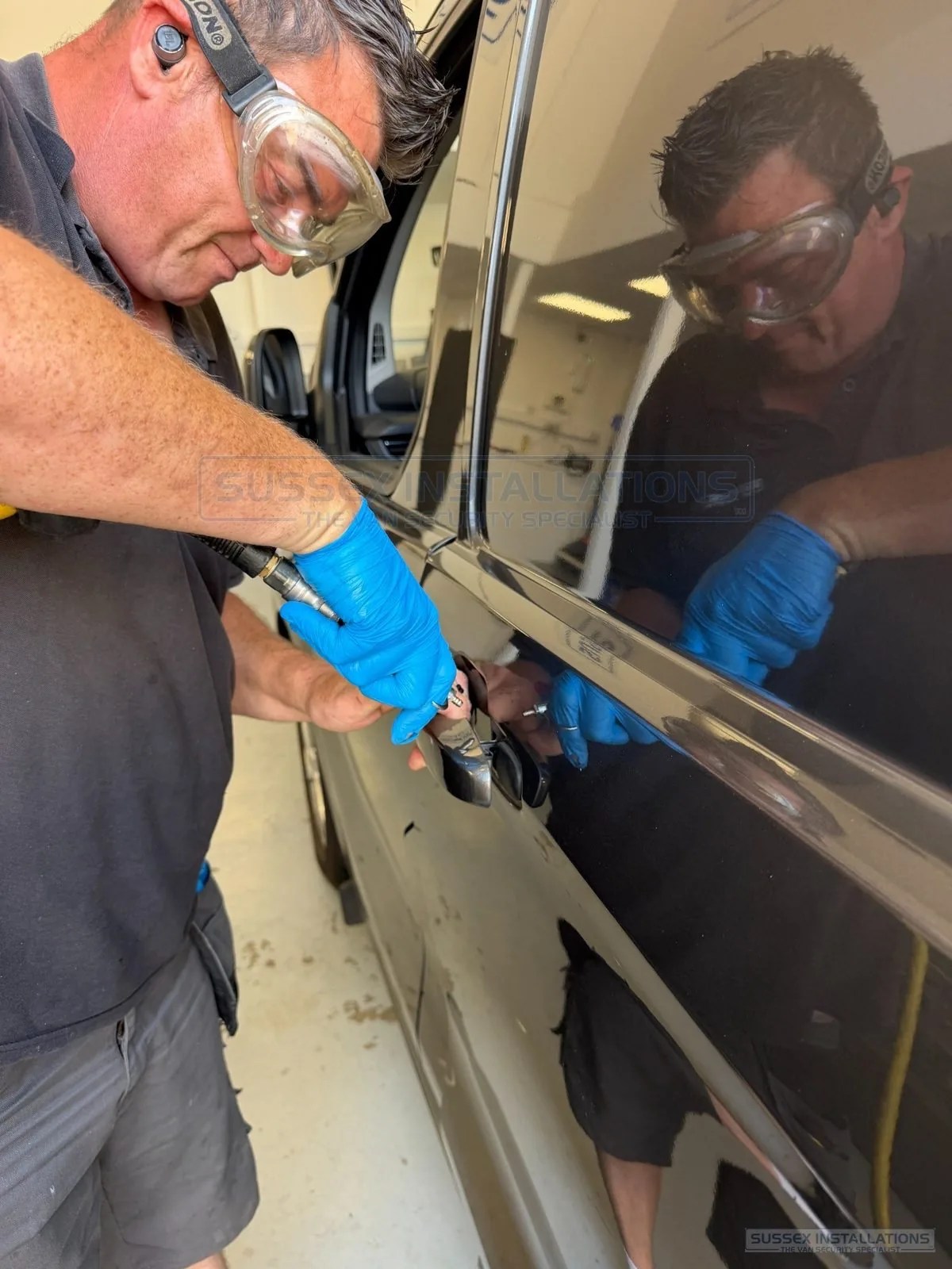 Close view of compressed air cleaning around a van handle