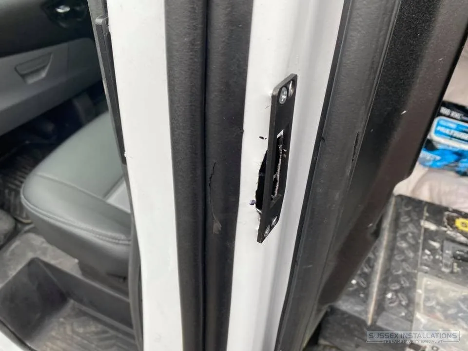 Uneven deadlock aperture cut into a van door edge