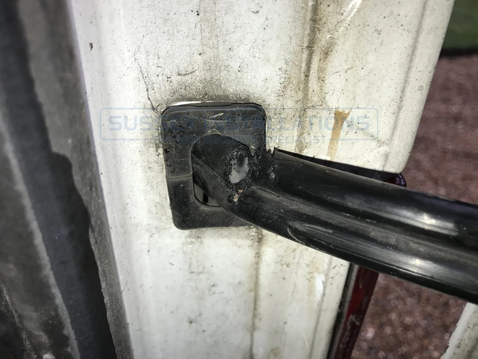 A wiring loom cut on the rear door of an MK7 Ford Transit