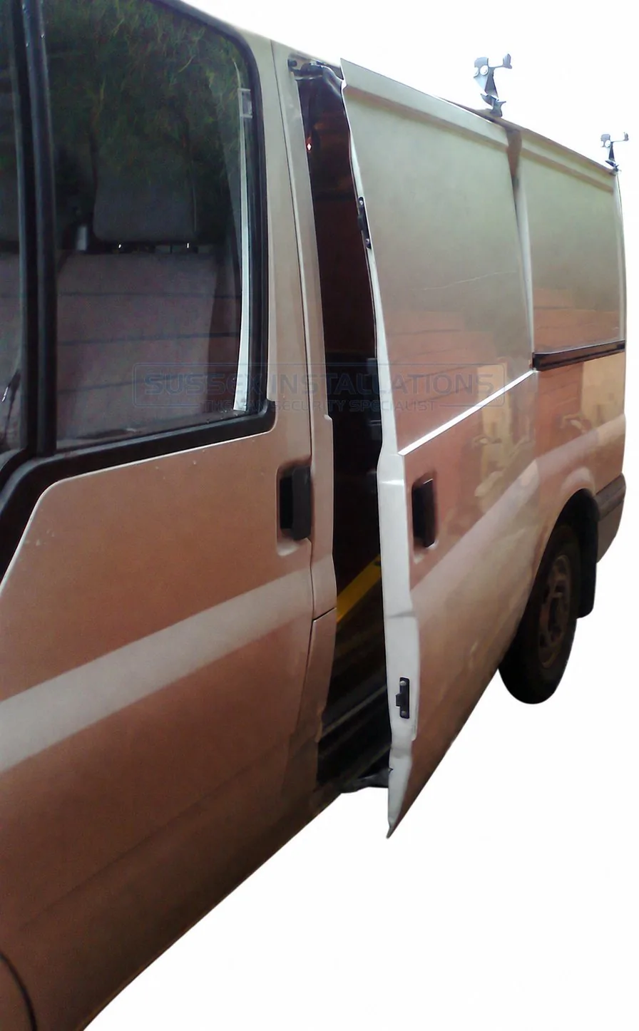 A Ford Transit side load door pulled off at the front and folded back like a suicide door
