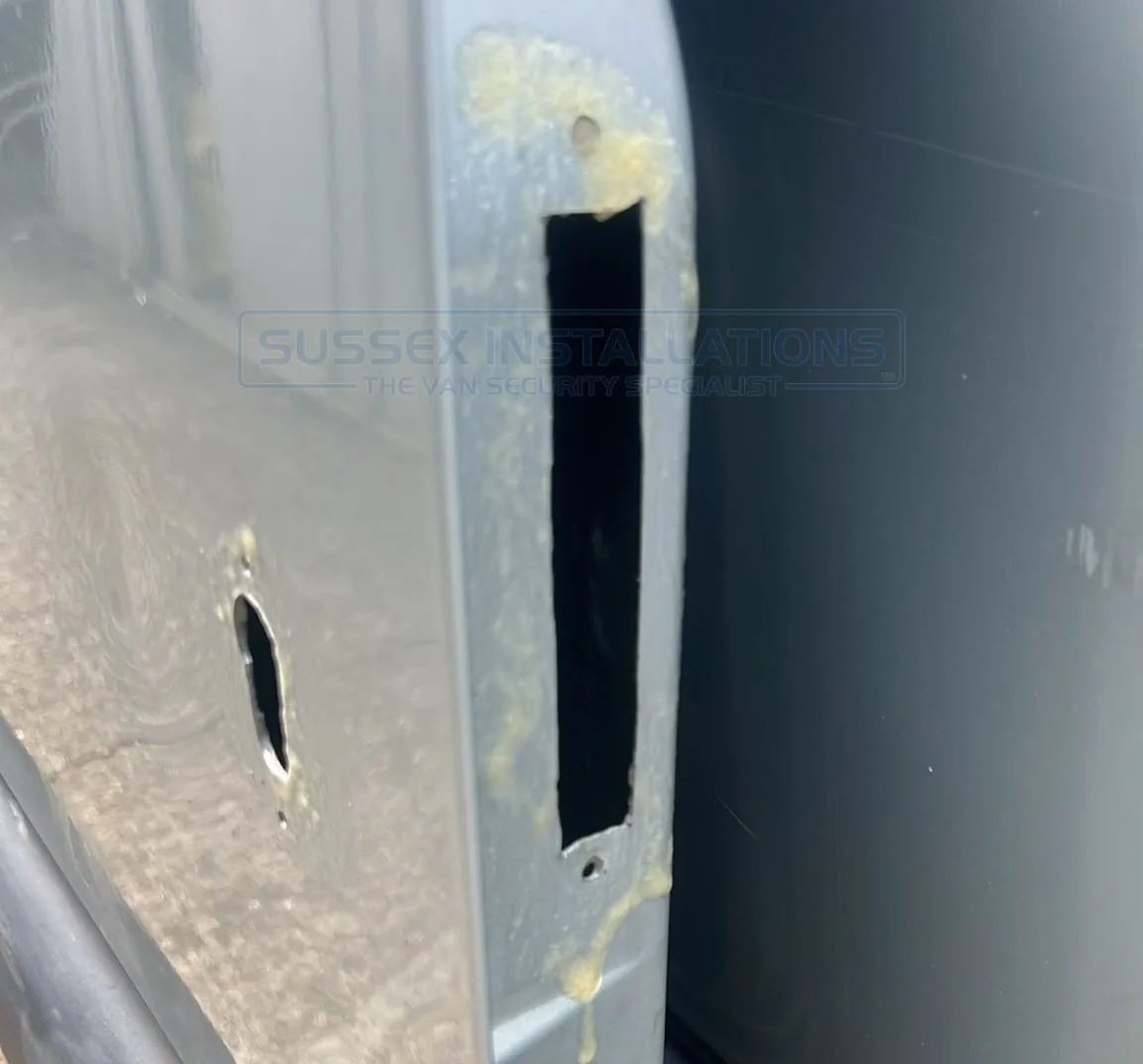 Wax corrosion inhibitor applied to bare metal around van lock apertures